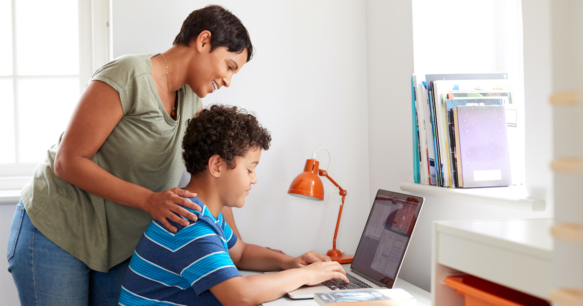 student on computer with parent